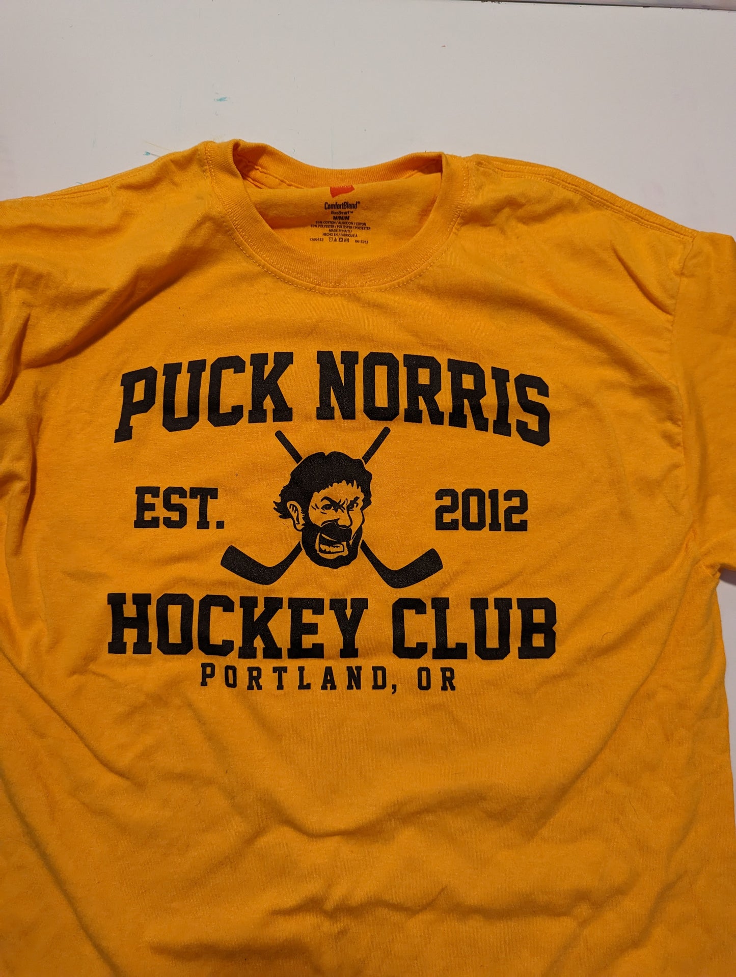 Puck Norris T Shirt Gold with Black Letters